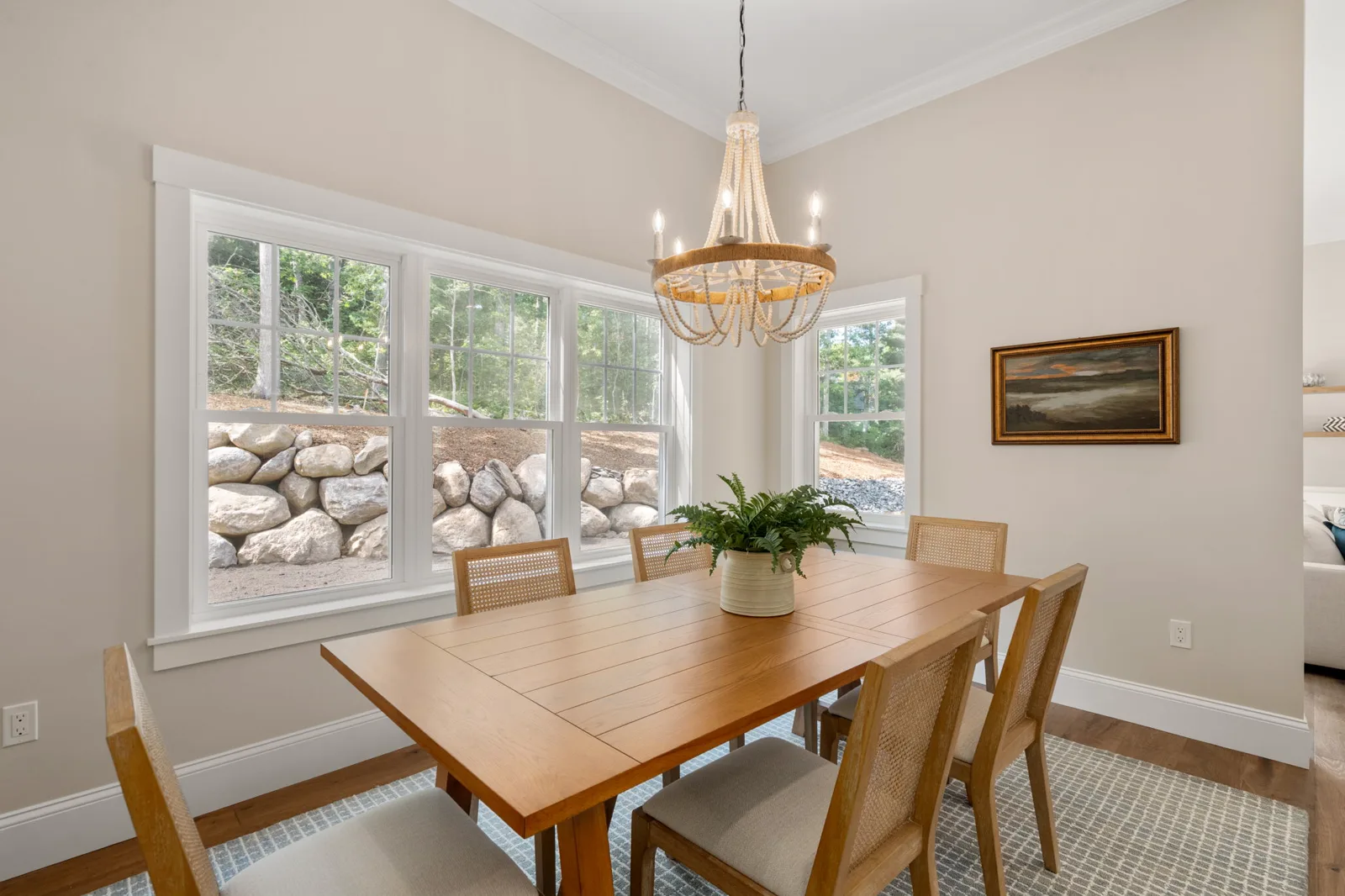 Dining area with wood table under a rope chandelier
