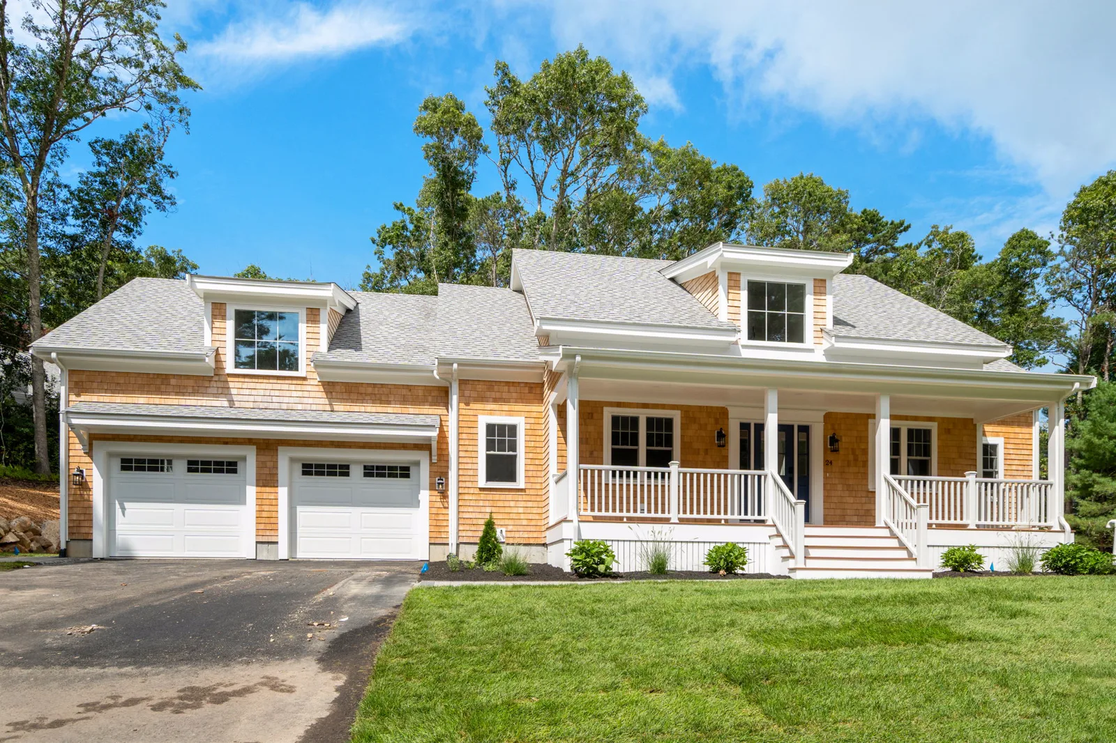 The finished 24 Country Farm Rd home in Forestdale — cedar shingles, farmer's porch and landscaped lawn