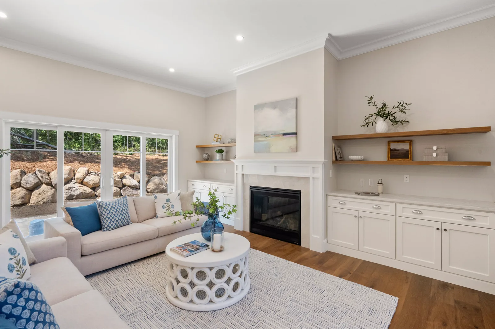 Living room with gas fireplace, custom built-ins and wide-plank oak floors