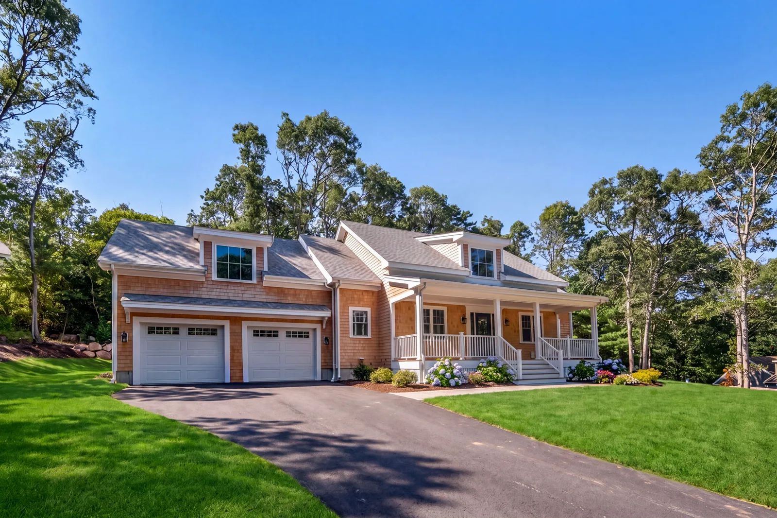 The completed Forestdale new build with cedar shingles, farmer's porch and landscaped lawn