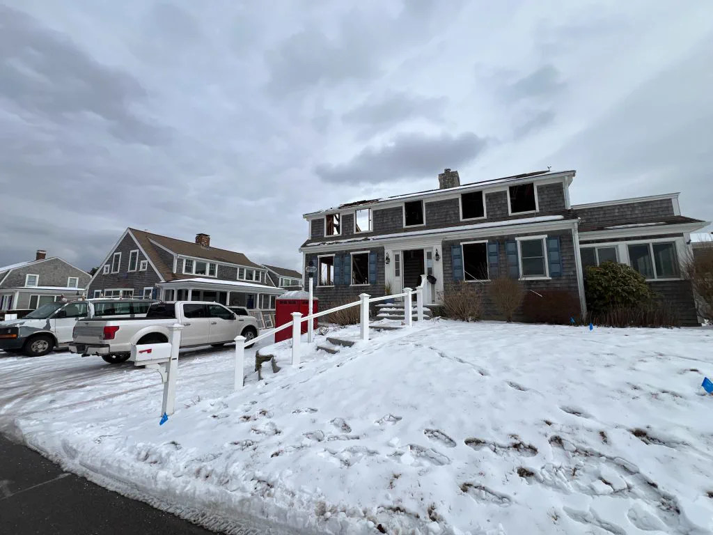 The original gray cape in Harwich Port before renovation, snow on the ground