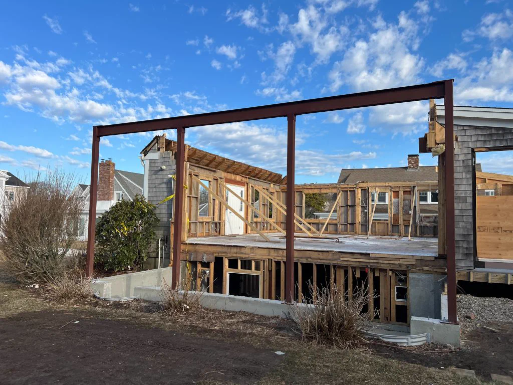 Structural steel frame and new framing going up on the stripped first-floor deck