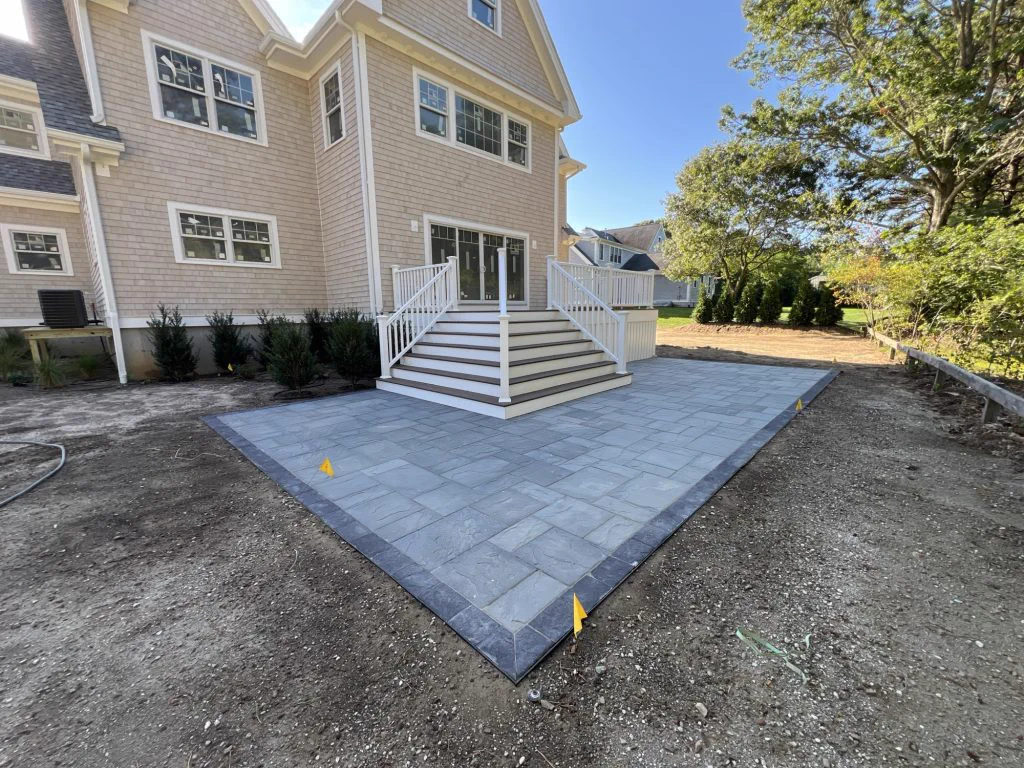 Finished rear of the Sandwich home with bluestone patio and stairs
