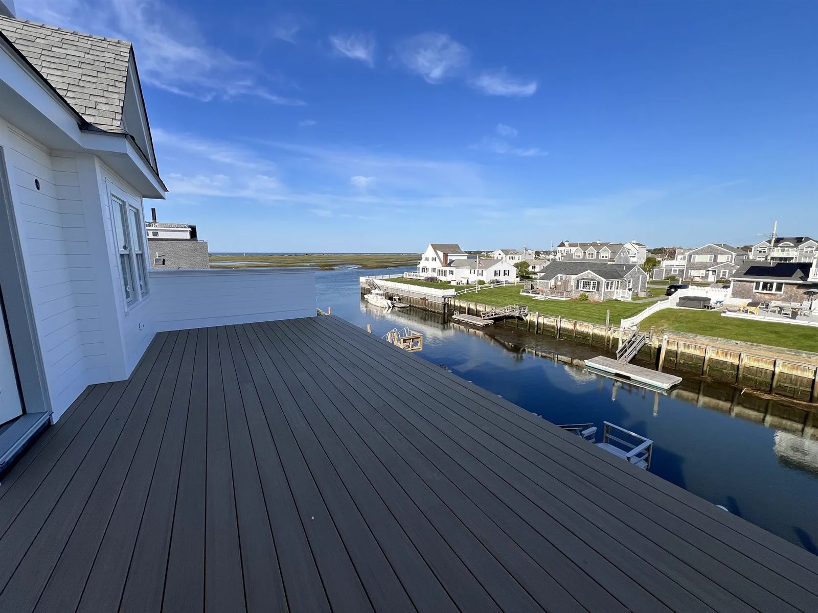 Composite deck on a new West Dennis home looking out over the water and docks